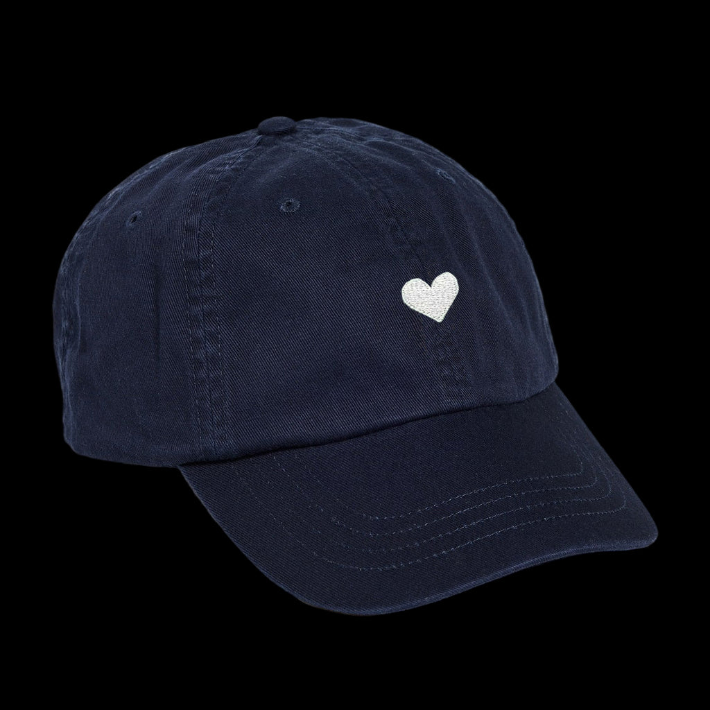 Navy blue cotton baseball cap with a white heart emblem embroidered by Atticus Poetry 
